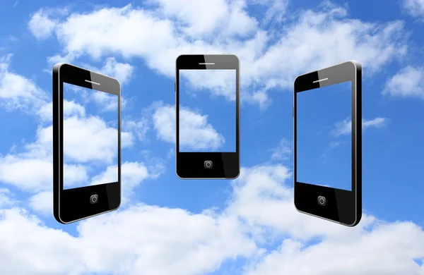 Tři moderní mobilní telefony na obloze — Stock fotografie
