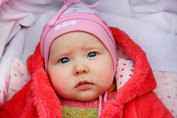 Little baby with sad sight in the perambulator — Stock Photo, Image