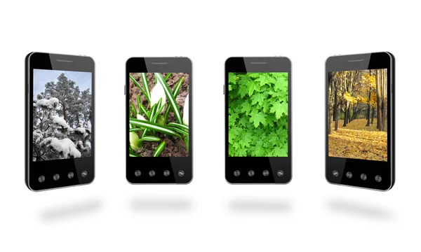 Cuatro teléfonos inteligentes con imágenes en color de las estaciones Fotos de stock