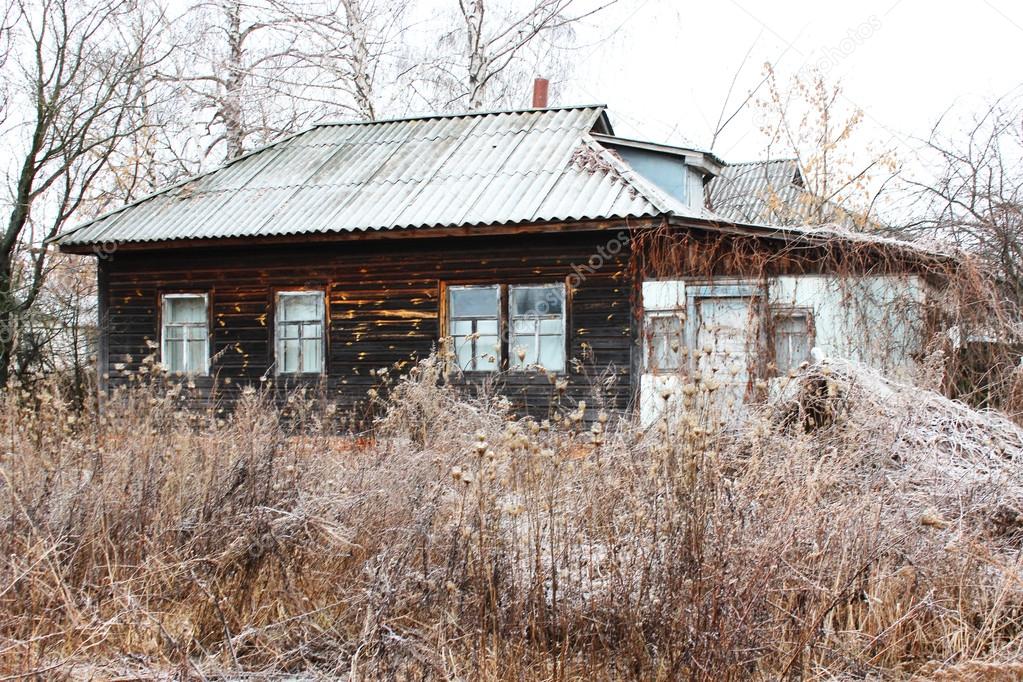 old rural house covered by hoar-frost