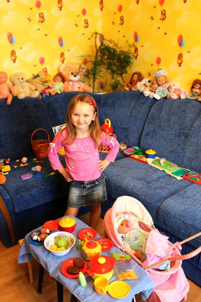 Little girl playing with toys in her room — Stock Photo, Image