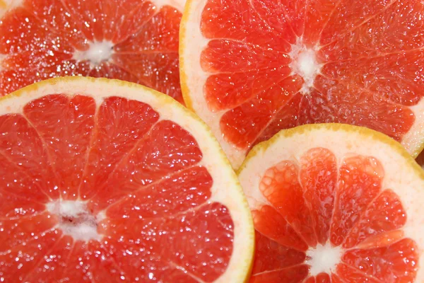 Grapefruits red cut by pieces — Stock Photo, Image