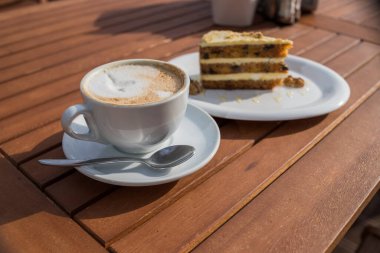 Havuç ve kremalı balkabağı pastası. Tabakta kremalı kahve. Lezzetli dilimlenmiş havuçlu kek.,
