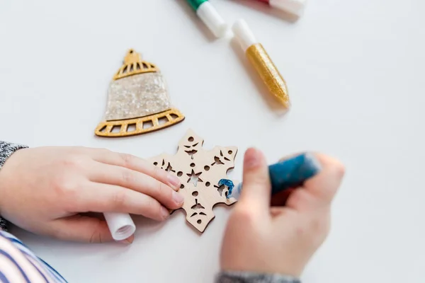 El yapımı Noel süslemeleri. Çocuklar Noel ağacı ya da hediyeler için dekor yapıyor. Noel el yapımı Diy Projesi. Sıfır atık kavram. Tahta Noel oyuncakları.