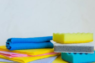 housework, housekeeping and household concept,cleaning stuff on white background.bottle of detergent, rubber gloves with rag ,sponge.domestic cleaning sanitary supplies.Copy space