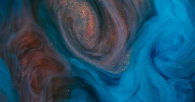 Ink blend. Swirl haze. Defocused blue orange colorful sparkling vortex splash glitter texture on abstract underwater art background.