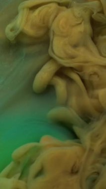 Dikey video. Su altı buharı. Arkaplanı boya. Odaklanmamış sarı turuncu yeşil renkli sis dokusu girdap dalgalı su sisi sanat soyutlamasında uçuyor.