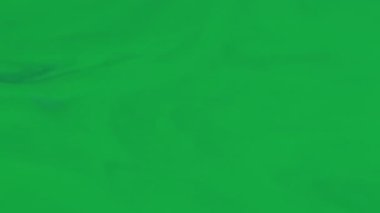 Mürekkep akışı. Akış sanatı. Su sıvısı mermer pigment karışımında bulanık yeşil boya soyut akrilik arkaplana yayılıyor..