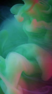 Dikey video. Duman patlaması. Haze girdabı. Kozmik soyut sıvıda renkli neon akış mürekkebi. Fantezi bulanıklığı siyah arkaplanda yeşil damla karışımı.