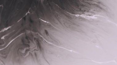 Ink emulsion. Blotch texture. Defocused black white color liquid flowing paint floating on abstract creative acrylic wet background.