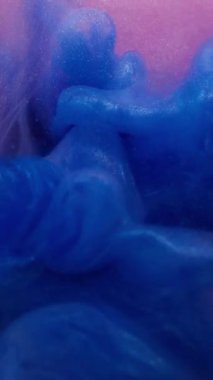 Dikey video. Bulut sıçraması. Köpüklü sıvı. Mavi parlak patlama, boya akışı. Sanat sisi bulanık pembe mor renkli su fantezi arkaplanı.