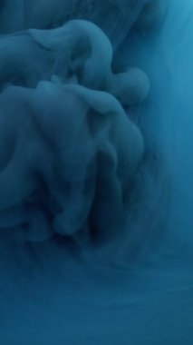 Vertical video. Art smog. Pigment blend. Black gray blue paint mixing cloud. Mystery dark wave dye explosion fluid abstract background blur texture.