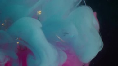 Sanat buharı. Eski bir ampul. Hasarlı camda parlayan bir çelenk. Siyah arkaplan bulanık su üzerinde pembe mavi duman harmanı renk mürekkebi