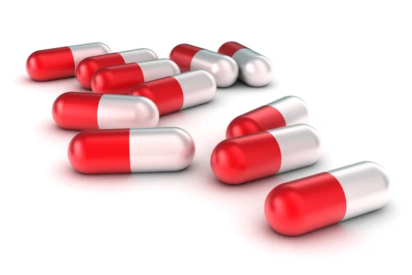 Um grupo de pílulas médicas em um fundo branco — Fotografia de Stock