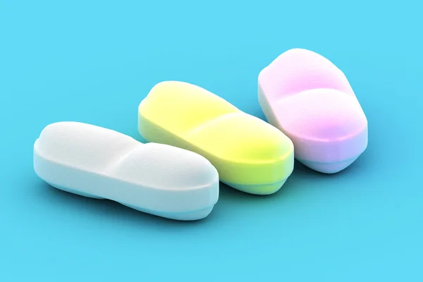 Um grupo de pílulas médicas em um fundo azul — Fotografia de Stock