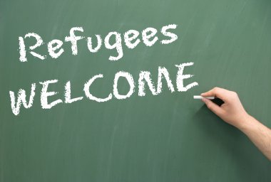 Chalkboard with the words Refugees Welcome clipart