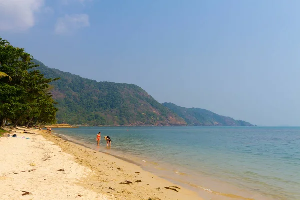 Two woman relax in water at beach Koh Chang Thailand