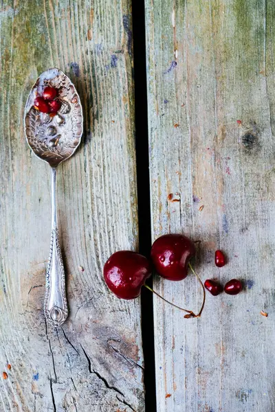Cherries Pomegranate Seeds Old Spoon Wooden Background — Stock Photo, Image