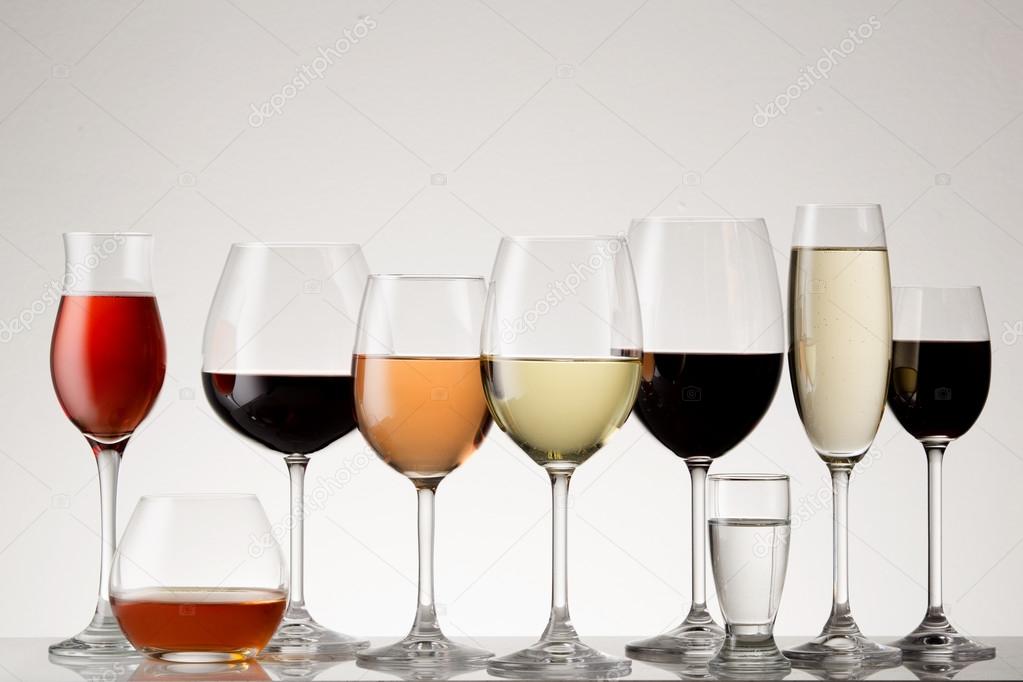 A collection of beautiful glasses with the appropriate drinks poured in.