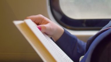 Trende kitap okuyan kadın 4K ağır çekimde 60fps
