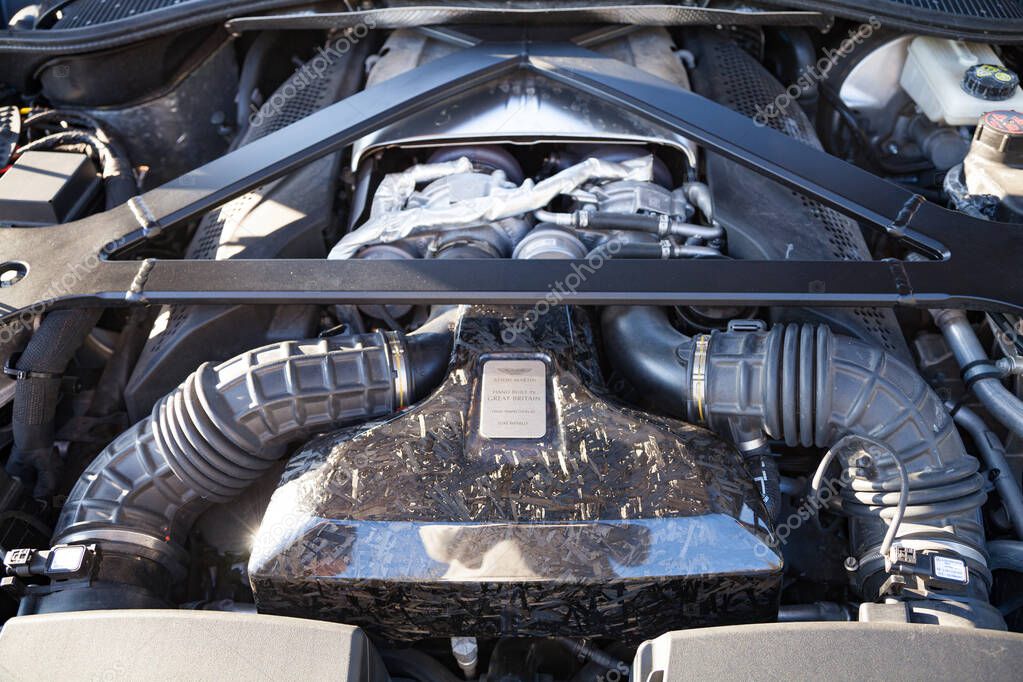 Vilnius, Lithuania - 2025-09-20 - Aston Martin engine close-up under the hood with carbon cover