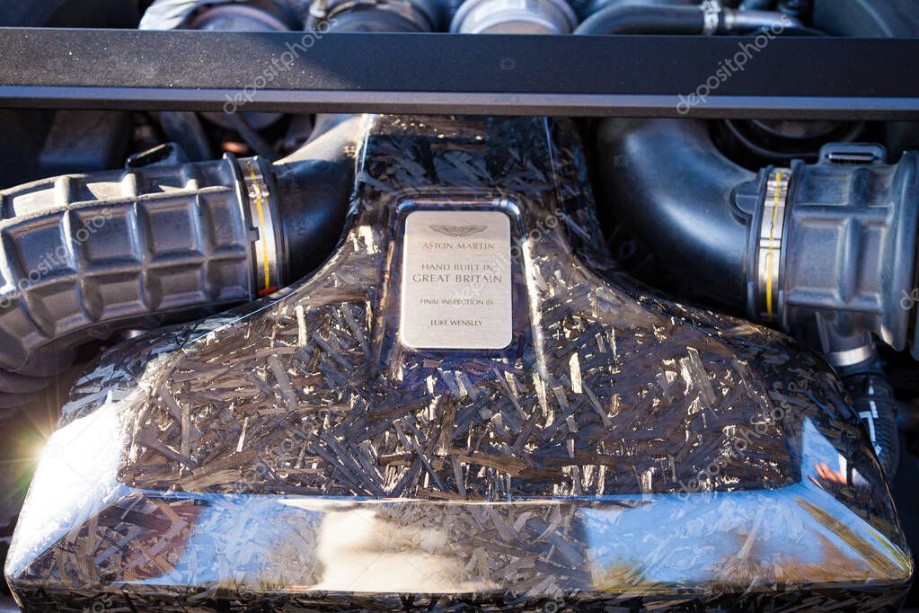 Vilnius, Lithuania - 2025-09-20 - Aston Martin engine close-up under the hood with carbon cover