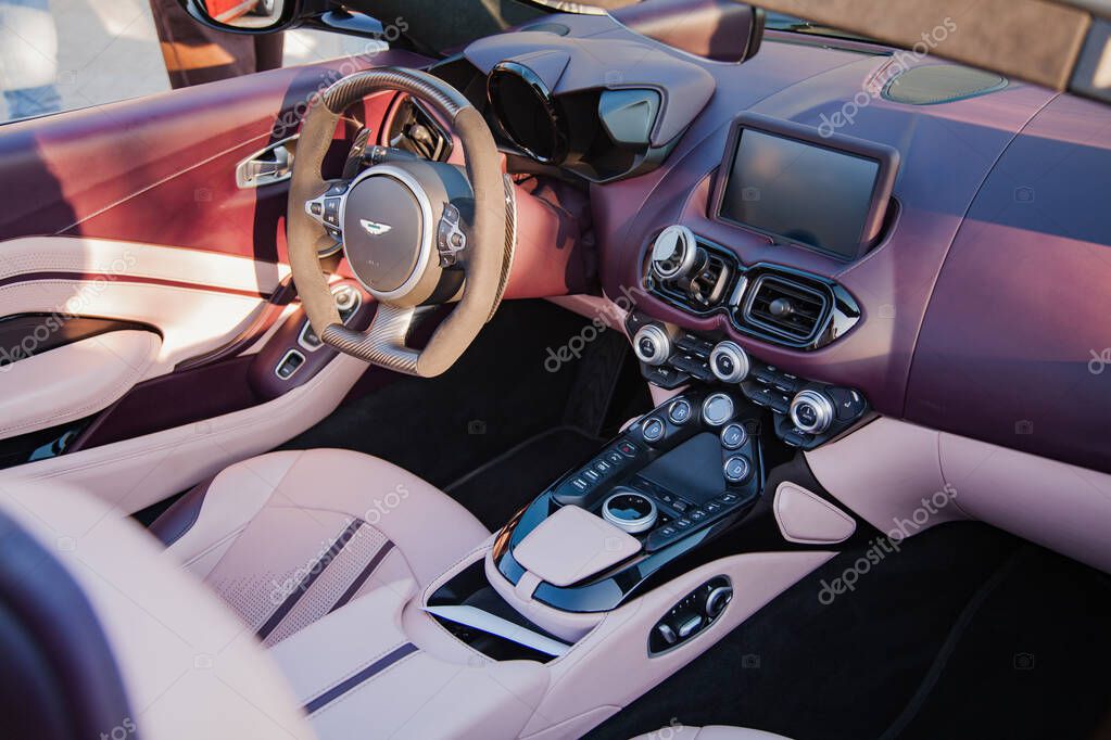 Vilnius, Lithuania - 2025-09-20 - Interior of Aston Martin DB11 with purple and pink leather design, view of driver seat and dashboard