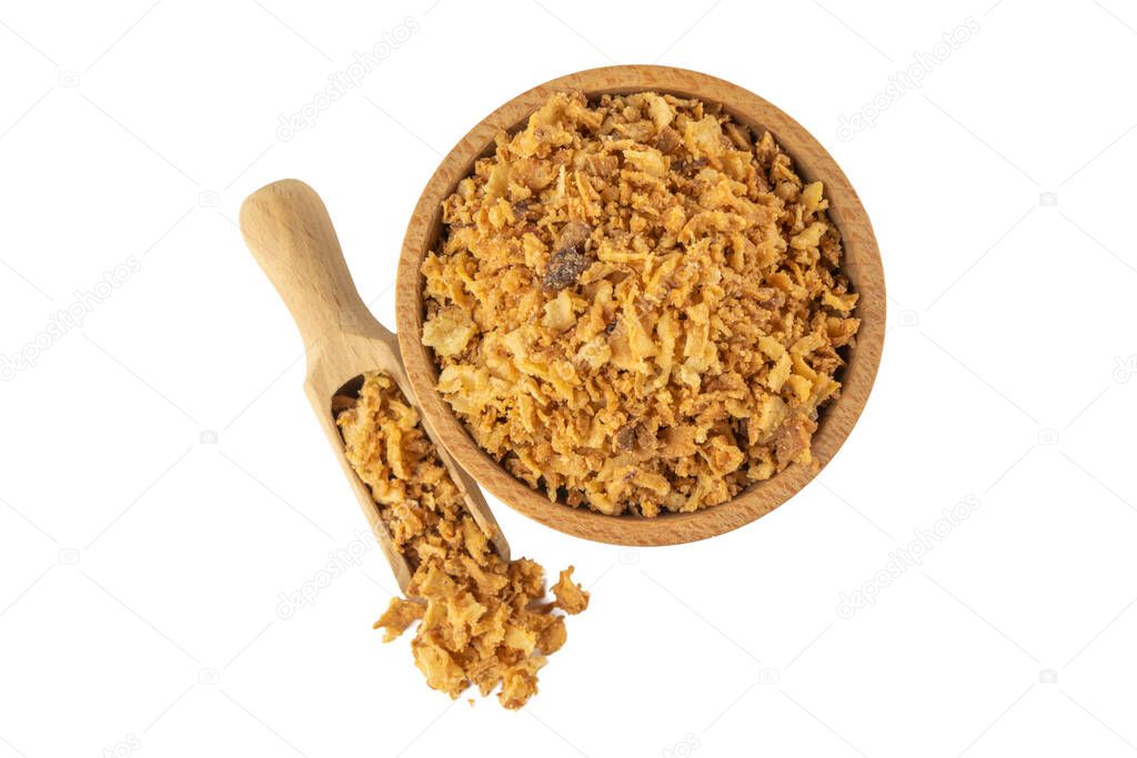 Crispy carmelized fried onion flakes in wooden bowl and scoop isolated on white background. Spices and food ingredients.