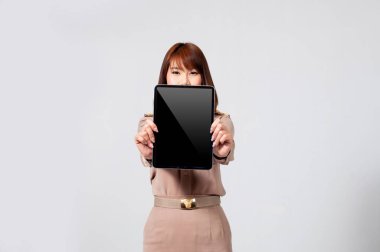 full body portrait Female thai teacher in uniform standing with white background holding tablet