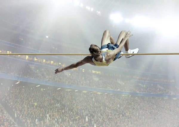 Athlete in action of high jump — Stock Photo, Image