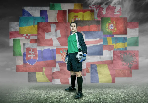 Soccer player on flags background — Stock Photo, Image