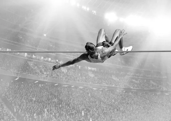 Athlete in action of high jump — Stock Photo, Image