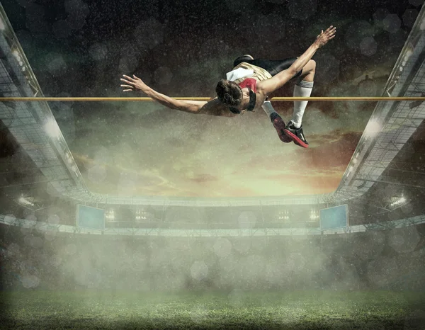 Sportovec v akci ve skoku vysokém — Stock fotografie