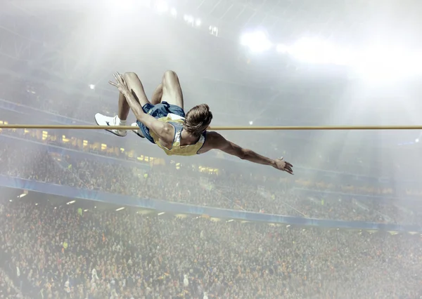 Athlete in action of high jump — Stock Photo, Image