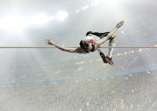 Athlete in action of high jump — Stock Photo, Image