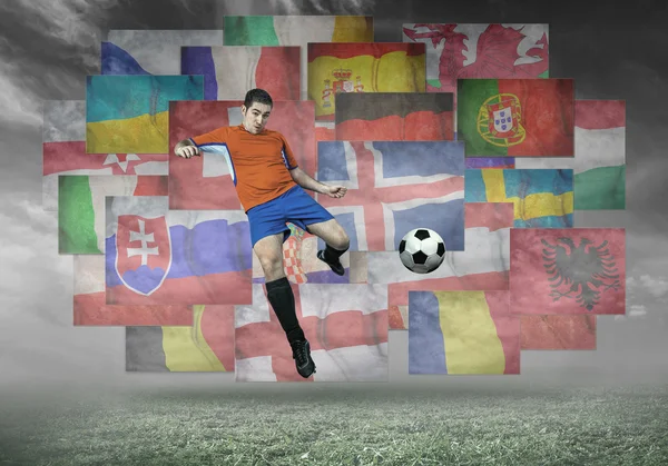 Soccer player on flags background — Stock Photo, Image