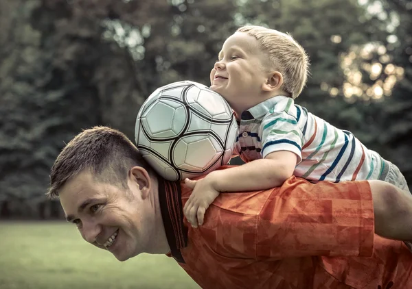 Father and son playing football — Stock Photo, Image