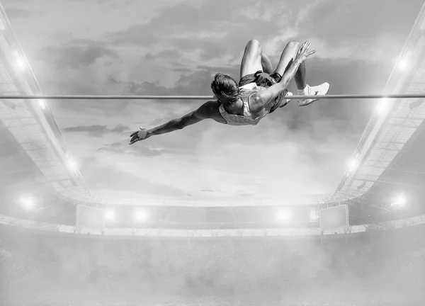 Athlete in action of high jump — Stock Photo, Image