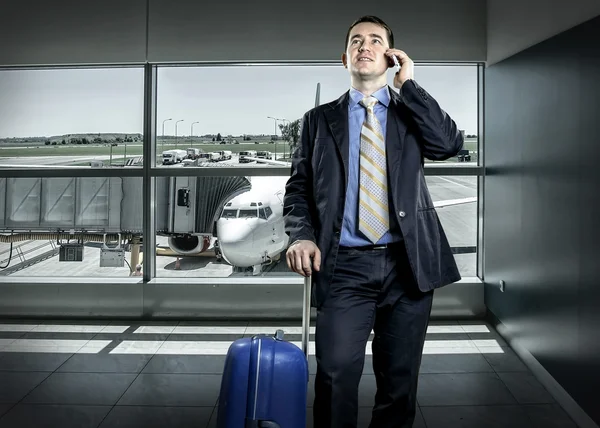 Businessman with baggage in airport — Stock Photo, Image