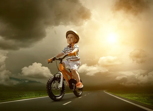 Child on orange bicycle — Stock Photo, Image