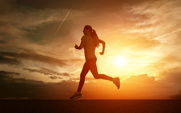 Beautiful silhouette of female running — Stock Photo, Image