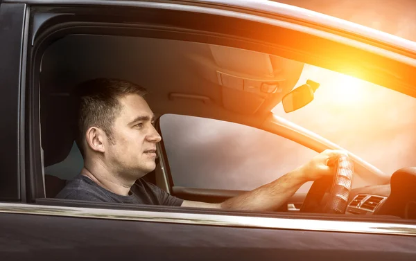 Man sitting and driving in car — Stock Photo, Image