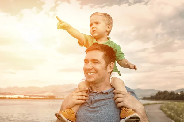 Son sitting on father — Stock Photo, Image