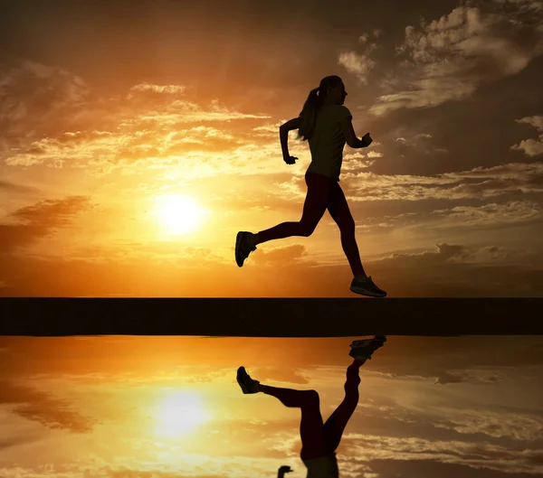 Beautiful silhouette of female running — Stockfoto