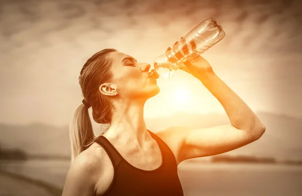 Mujer bebe agua después de correr — Foto de Stock