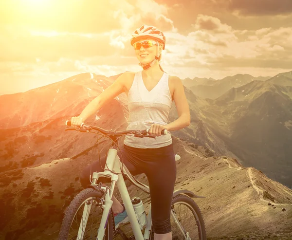 Woman in helmet  on the bicycle — Stock Photo, Image