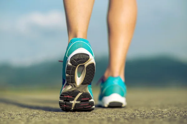 Runner athlete feet running on road — Stock Photo, Image