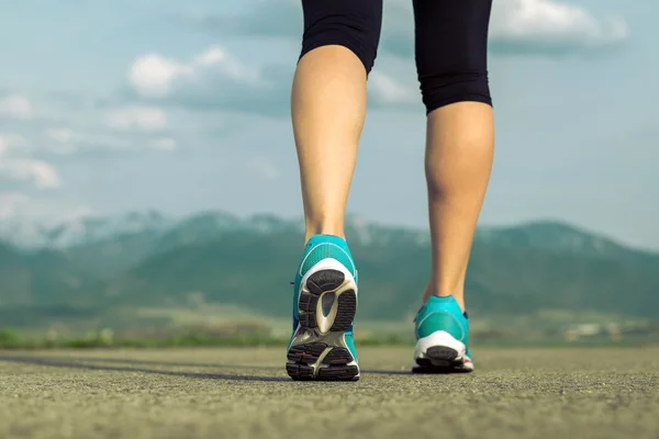 Runner athlete feet running on road — Stock Photo, Image