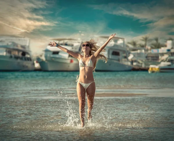 Happy female running on beach — Zdjęcie stockowe