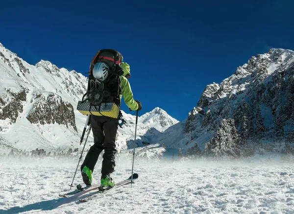 Homem com mochila no esqui nas montanhas — Fotografia de Stock